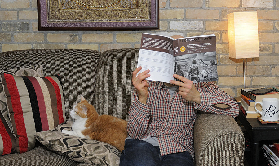 Ron Schafrick's reading space: the author with magazine and cat