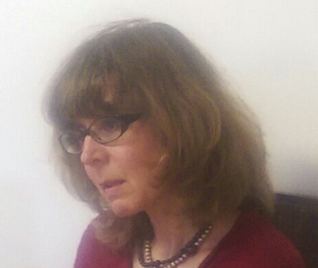 Photo of the author: She has shoulder-length brown hair, and is wearing glasses.